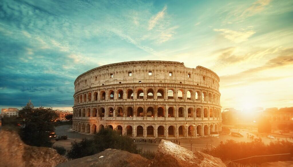 Beautiful shot of the famous Roman Colosseum amphitheater under the breathtaking sky at sunrise