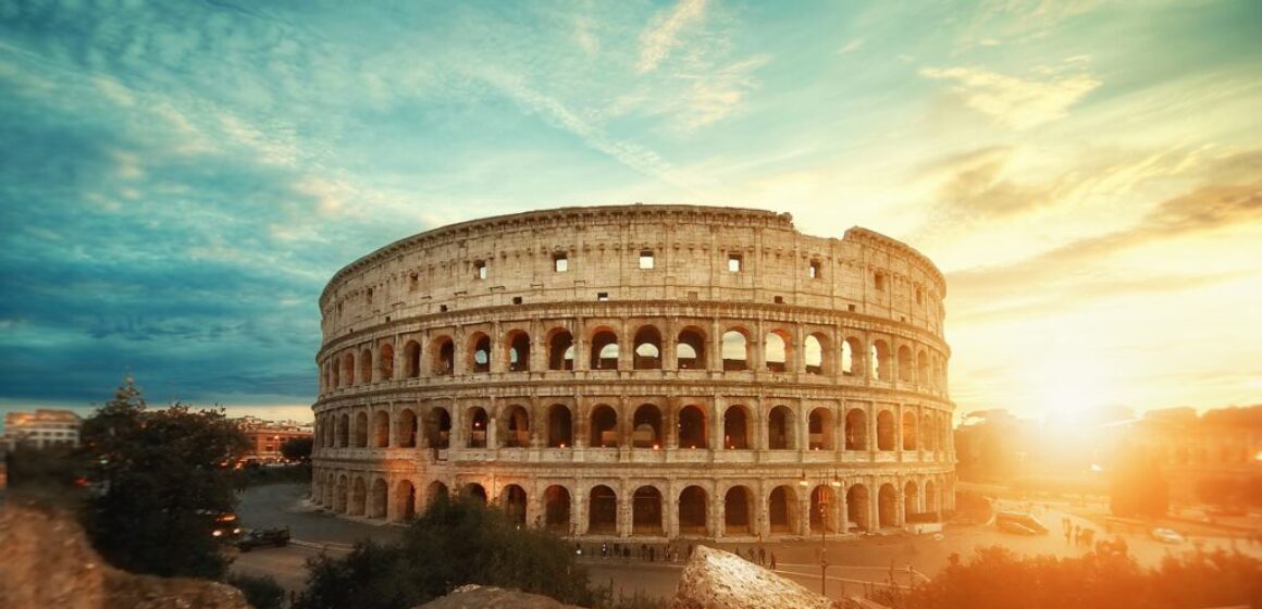 Beautiful shot of the famous Roman Colosseum amphitheater under the breathtaking sky at sunrise